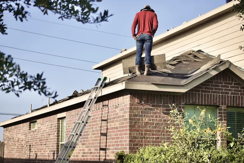 Professional roofer working on a residential roof in Meisterwood